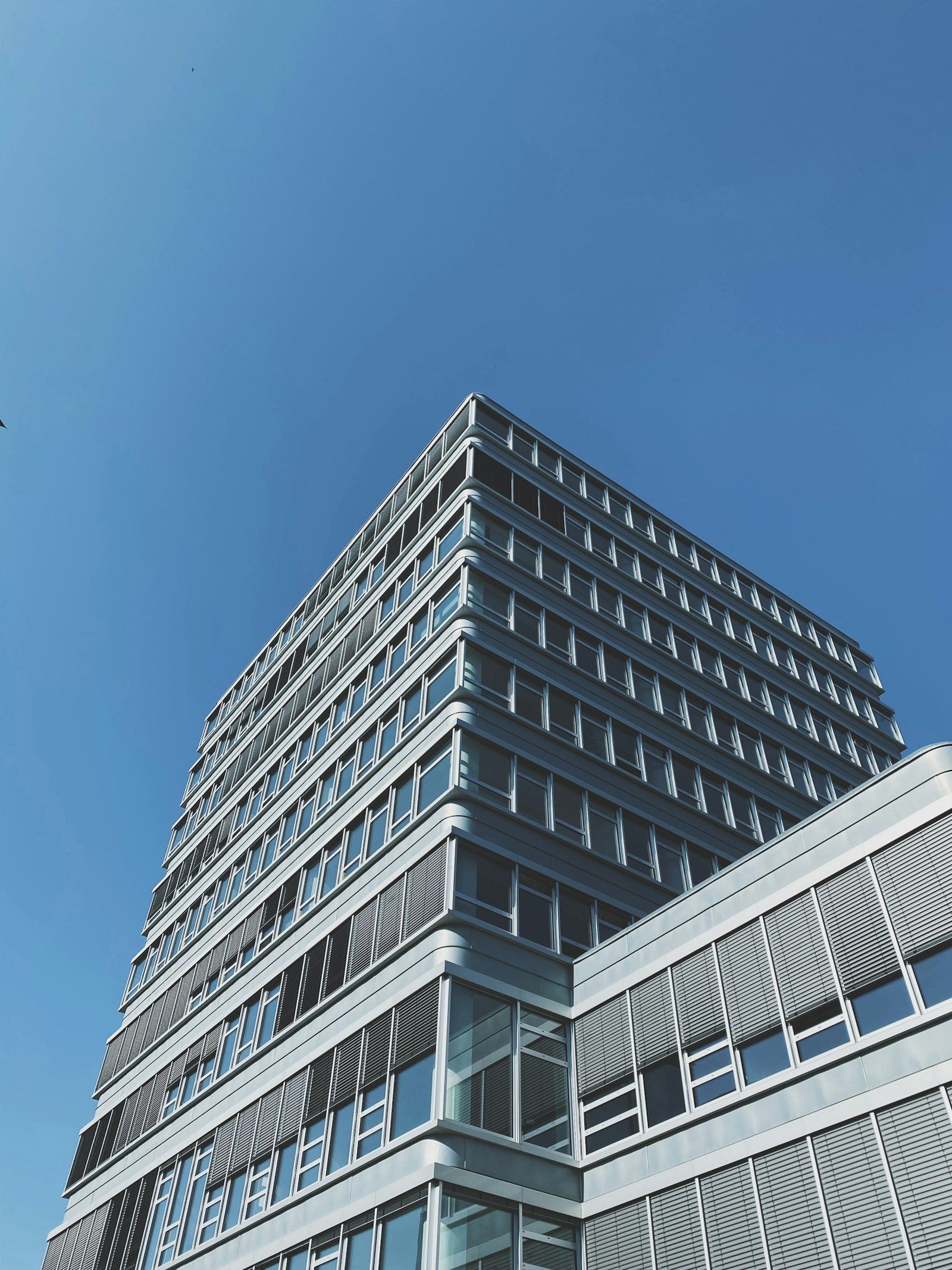 Tall commercial building with stacked exterior terraces
