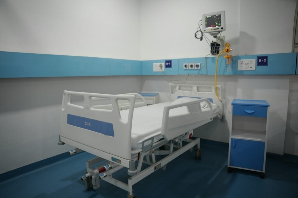 Patient room with an adjustable hospital bed and clinical equipment