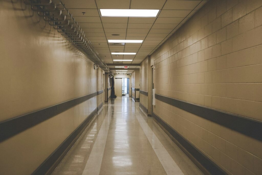 Clinical corridor with wall protection and doorways along a clear access route