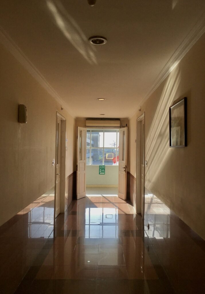 Interior corridor with glazed doors and a visible access route