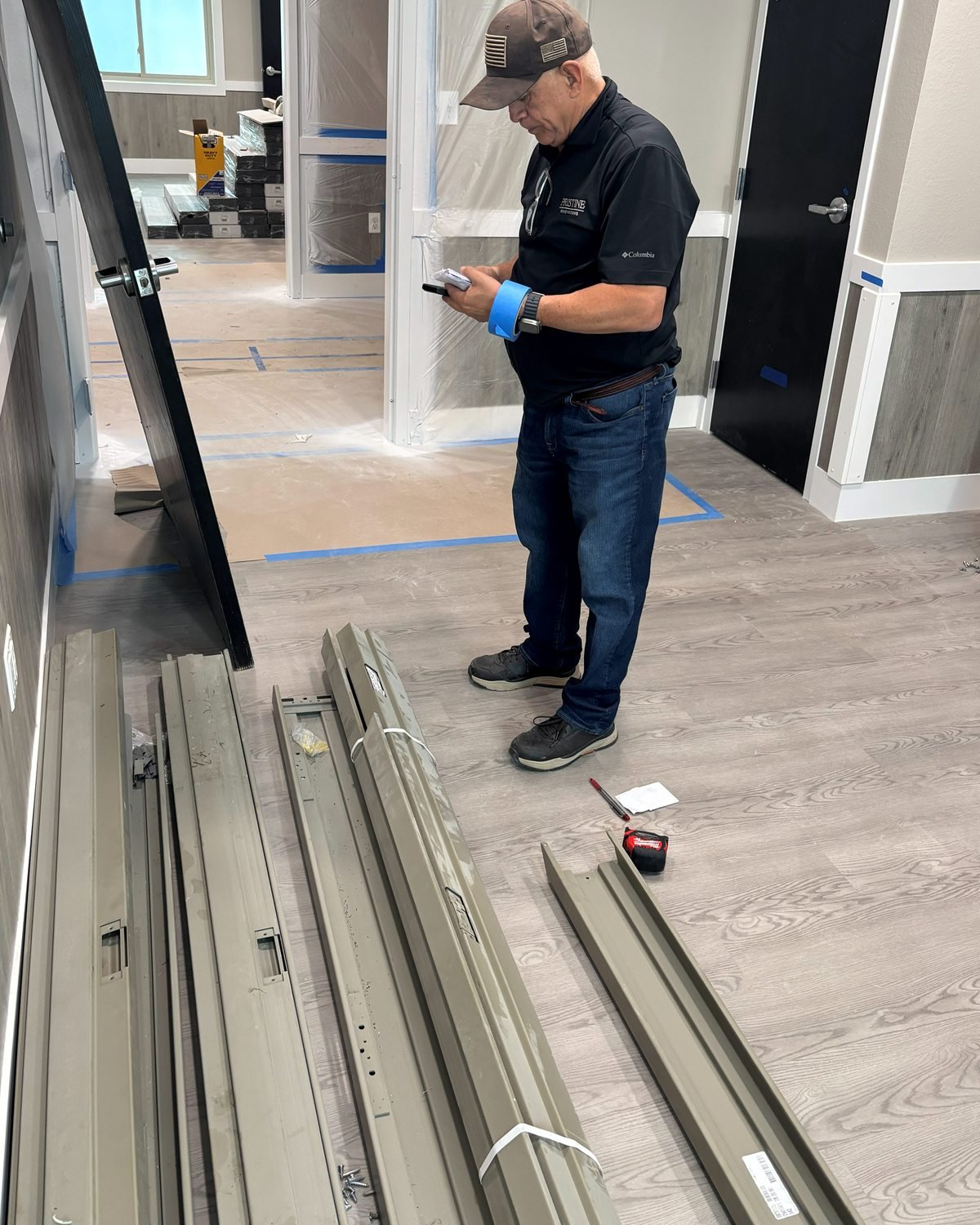 Pristine team member reviewing information on a handheld device at a renovation site