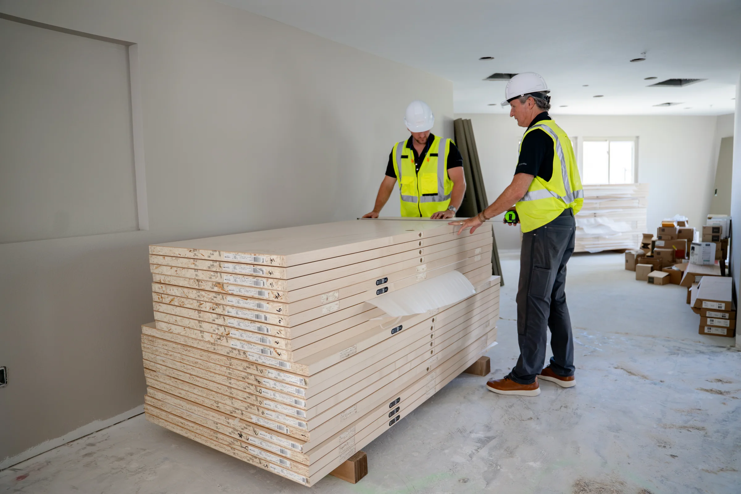 Pristine crew reviewing stacked doors at an interior renovation site