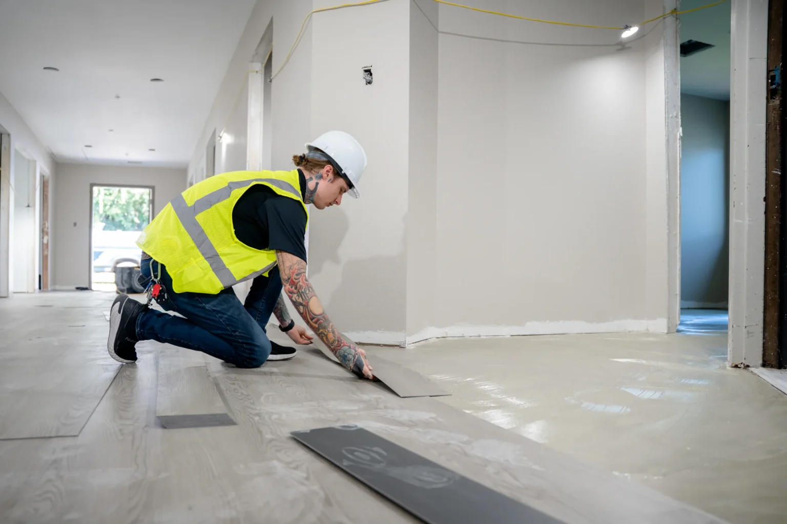 Pristine installer fitting flooring inside a renovation work area