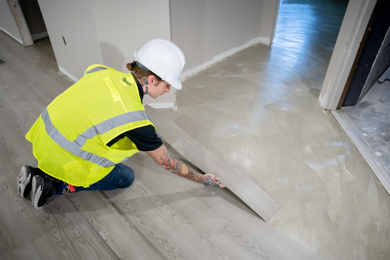 Close view of a Pristine installer aligning a floor plank