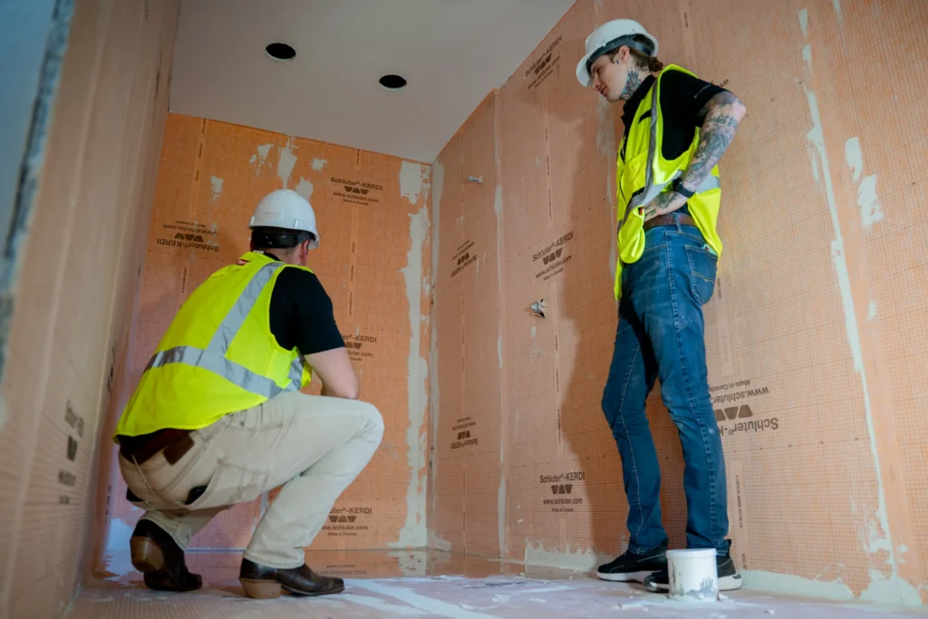 Pristine crew reviewing wall preparation in a renovation work area
