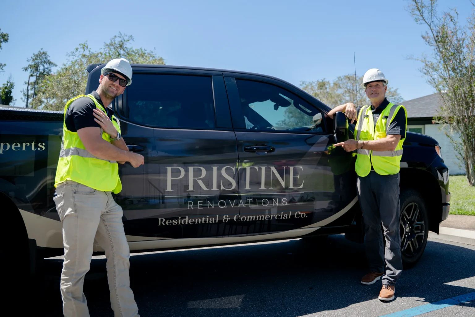 Pristine crew standing beside the company-branded truck