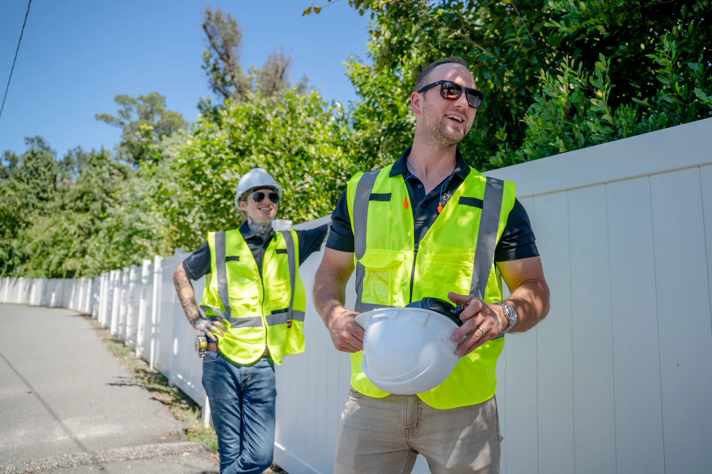 Pristine team outdoors with safety vests and hard hats