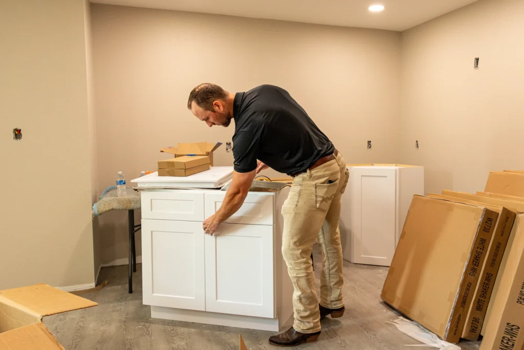 Pristine team member assembling cabinetry inside a renovation work area