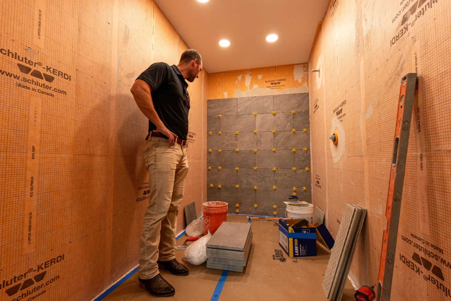 Pristine team member inspecting a tile installation and work area
