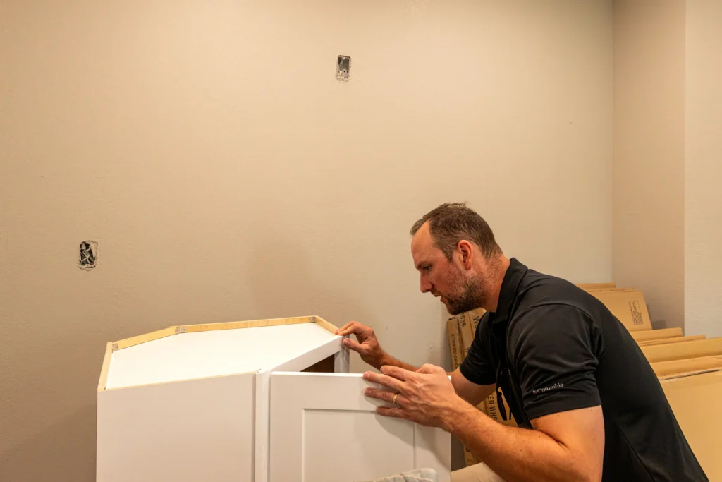 Pristine team member checking the alignment of assembled cabinetry