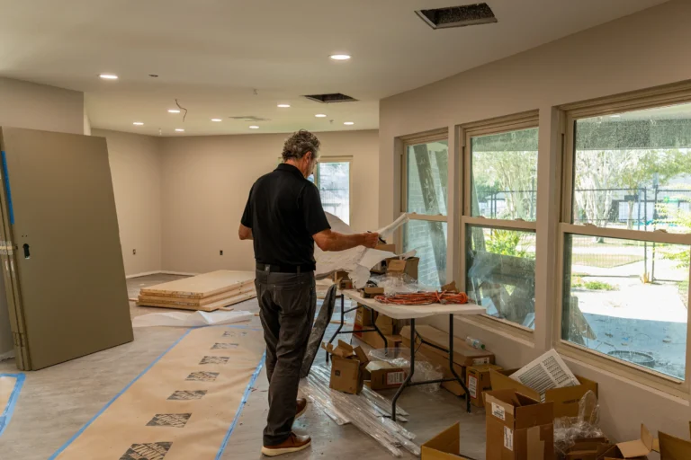 Pristine team member reviewing construction drawings at a protected worksite